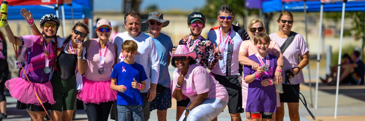 PinkStrong Ride cyclists celebrating at the finish line during Central Texas’ fun and supportive breast cancer awareness ride held every first Sunday in October in Hutto, TX.