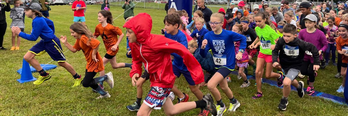 Youth trail runners taking off at the start of the Smallfoot Trail Fest