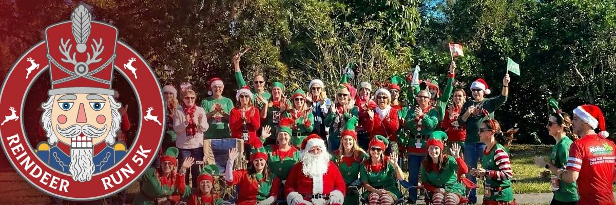 Reindeer Run 5K nutcracker logo beside Santa and a crowd of runners in elf costumes