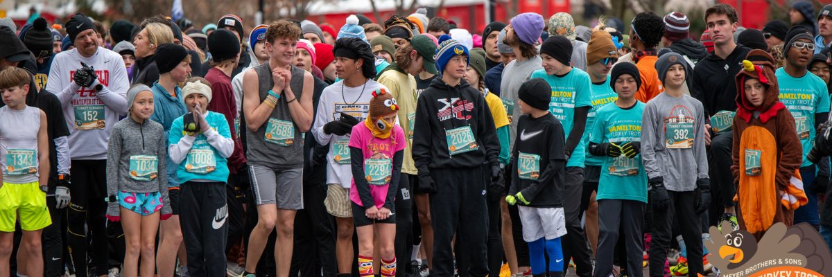 The start line at the 2025 Meyer Brothers & Sons Turkey Trot with runners trying desperately to stay warm as they wait for the starting gun.